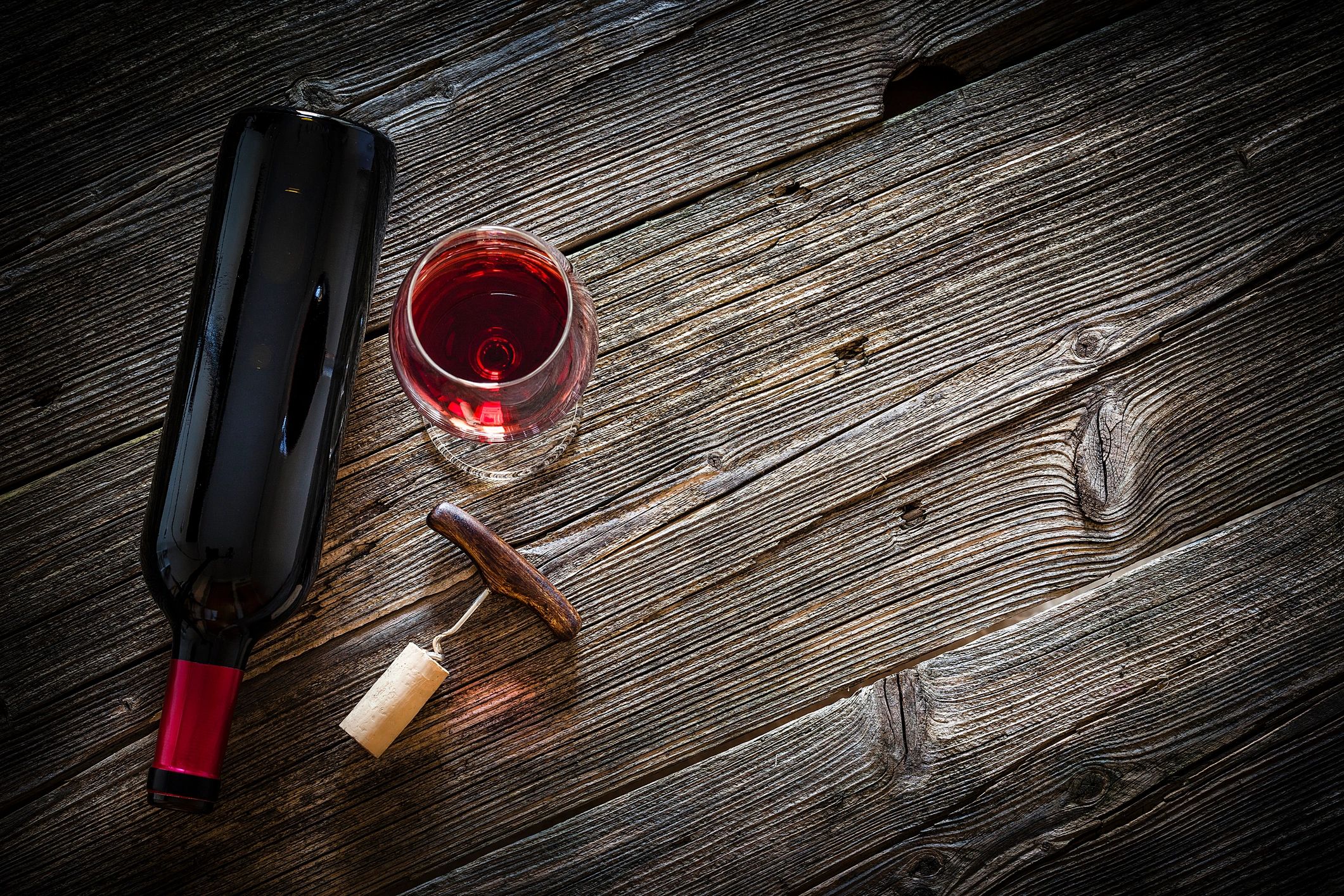 Wine bottle and glass on rustic wooden table